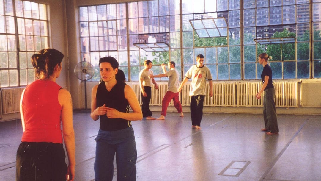 A Muzosa class at the large, windowed dance studio at Alvin Ailey Studios, our first indoor training space. 5 students are following training instructions given by head instructor Jeff Christian.